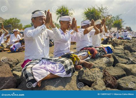 Balinese Young Men In Traditional Custome Praying Together During Hindu