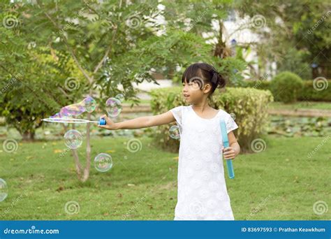 7 Years Old Asian Girl Enjoy With Soap Bubbles In Park Stock Image Image Of Hair Black 83697593