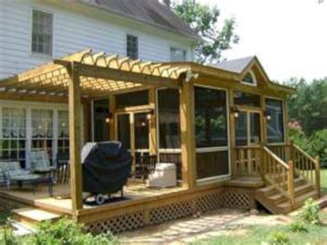 A Covered Patio With Chairs And A Grill On The Back Deck In Front Of A