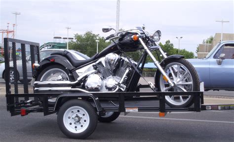 Motorcycle carrying trailers may be open or enclosed. Motorcycle trailer