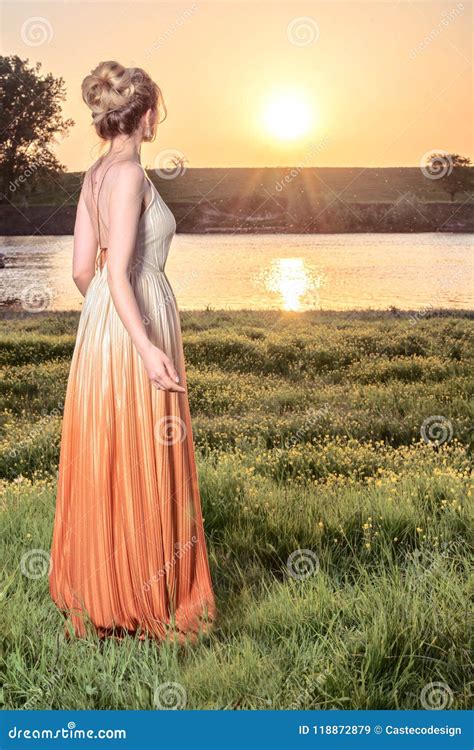 Woman Watching The Sunset In A Long Glamorous Dress Beautiful