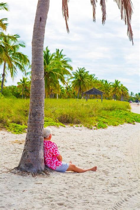 Vertical Shot Of A Man Resting Under The Palm Tree Stock Image Image