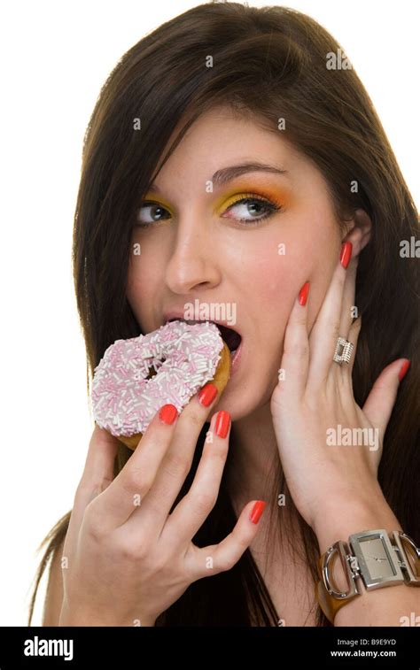 Woman Eating A Donut Stock Photo Alamy