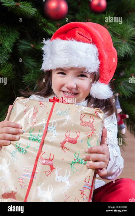 Joyful Little Girl Child With Her T Box Under Christmas Tree She