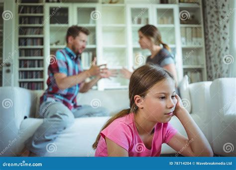 Sad Girl Listening To Her Parents Arguing Stock Photo Image Of House