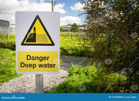 Danger Deep Water Warning Sign Close Up By Rural Waterway River Stream