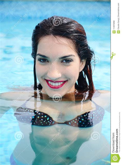 Beautiful Young Woman Relaxing In Water By The Swimming Pool Stock