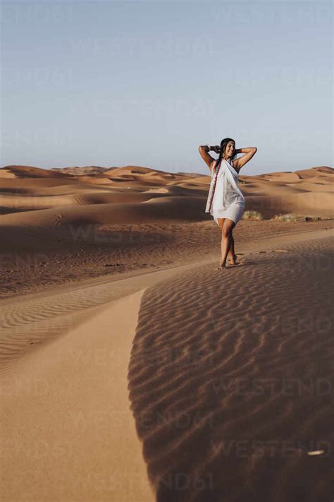 Beautiful Young Woman Walking In The Desert Merzouga Morocco Stock Photo