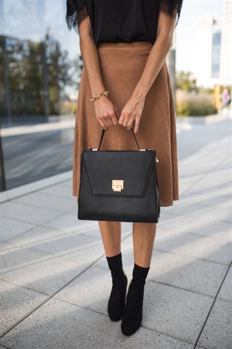 The Miller Affect Carrying A Black Structured Handbag From The Styled