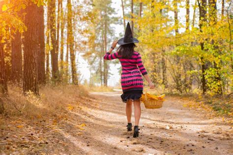 Beautiful Skinny Brunette Witch In A Witch S Hat Walks In The Autumn