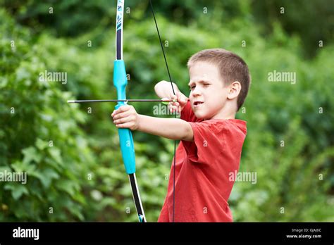 Little Archer With Bow And Arrow Outdoors Stock Photo Alamy