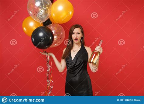 Irritated Young Woman In Black Dress Spread Hands Celebrating Hold