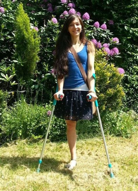 Amputee Woman With Crutches In A Beautiful Setting