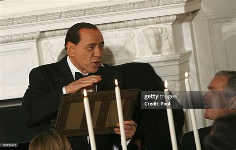 Italian Prime Minister Silvio Berlusconi Holds Part Of The Podium He