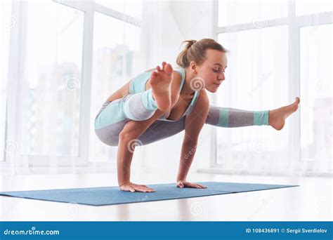 Beautiful Woman Practices Handstand Yoga Asana Tittibhasana Firefly Pose At The Yoga Studio