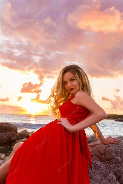 Premium Photo Beautiful Young Sexy Blonde Posing In Evening Red Dress