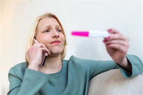 Premium Photo Shocked Woman Looking At Control Line On Pregnancy Test