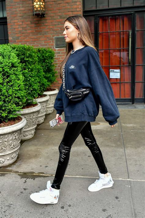 madison beer dons a nike sweatshirt pvc pants with off white jordan 1 sneakers as she steps out
