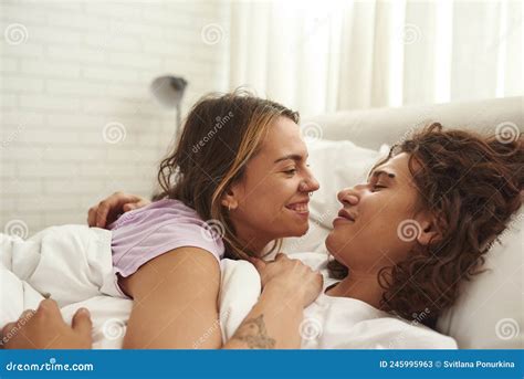 caucasian couple hug and look at each other on bed stock image image of couple morning 245995963