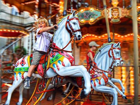 Premium Photo Portrait Of Boy Riding Carousel Horse