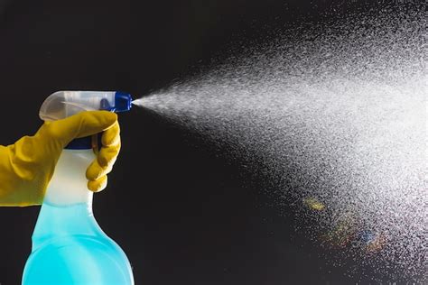 Janitors Hand Spraying Detergent With Spray Bottle Free Photo