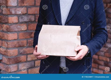 Close-up Paper Package for Delivery in Male Hands. Express Delivery