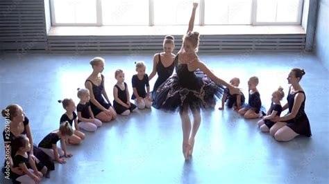 Girl Dancer In Ballet School Learns To Dance Little Ballerina In Training In Black Dancing Suit