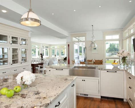 White cabinets and marble counters create a crisp, clean base for a light blue focal wall. Granite or Quartz Countertops? | Rose Anne Erickson