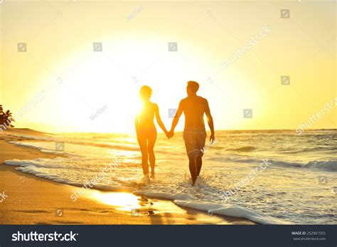 Honeymoon Romantic Couple In Love Holding Hands Walking On Beautiful