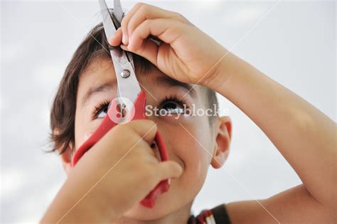 Kid Cutting Hair To Himself With Scissors Funny Look Royalty Free