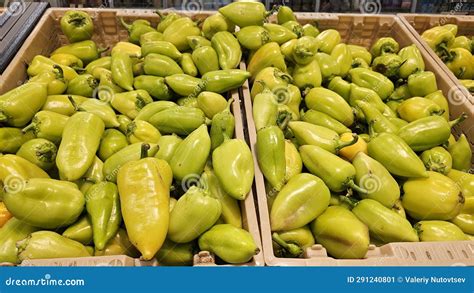 A Scattering Of Green Peppers On The Counter Of A Vegetable Store