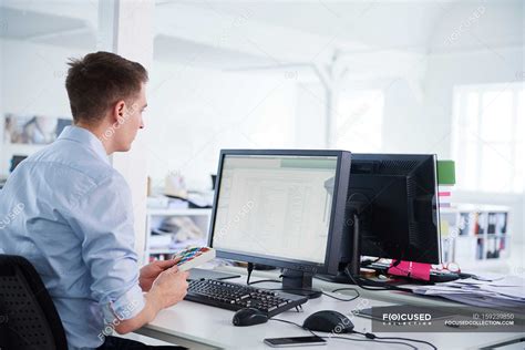 Man in office using computer — natural light, businesspeople - Stock Photo | #159239850