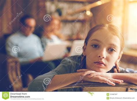 bored lonely girl looking into camera at home stock image image of device braids 101687507