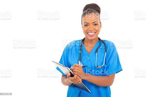 African Medical Intern Doctor Writing On Clipboard Stock Photo