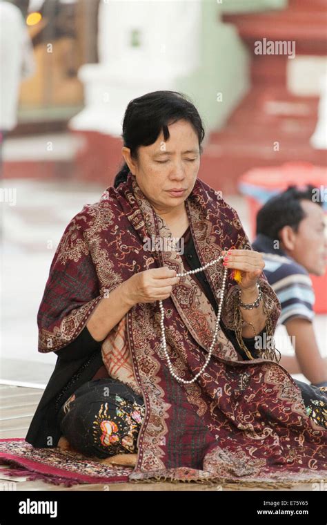 Buddhist Woman In Morning Prayer At The Shwedagon Pagoda With Prayer