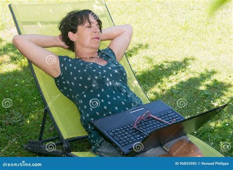Happy Mature Woman Relaxing Resting On The Deck Chair In Garden Stock Image Image Of Outdoors