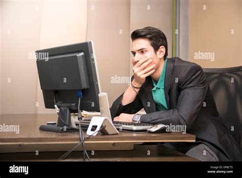 Preoccupied Worried Desperate Young Male Worker Staring At Computer