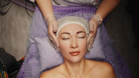 Woman Receiving Anti Ageing Facial Massage In Spa Salon Relax Wellness