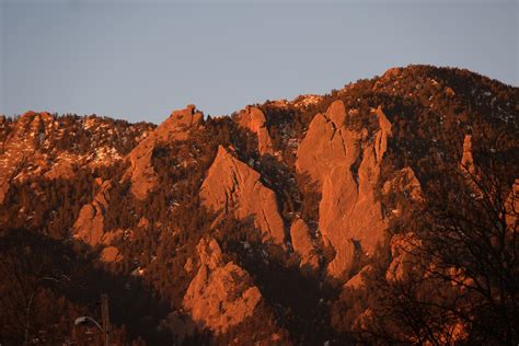 As The Sun Rises Up In The East The Flatirons In Boulder Glow This