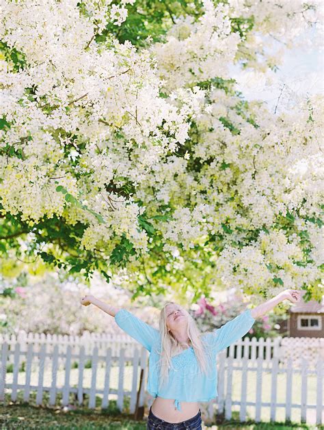 Blonde Girl Yelling For Joy In Front Of Showering Floral Tree Del