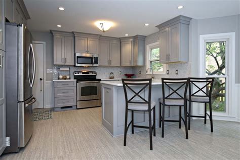 A kitchen remodel in riverview, florida transformed a kitchen from bland and colorless to bold and modern. Savvy Gray Cabinet Kitchen Remodel with Island Seating ...