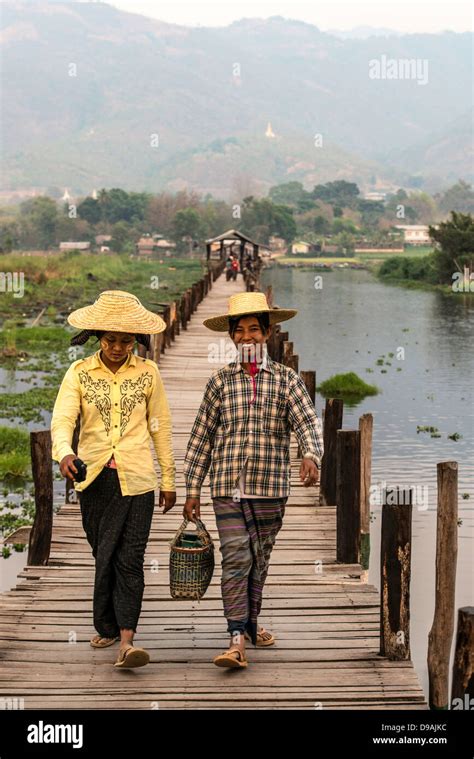Burmese Girls Crossing A Bridge On Their Way Back To The Village Inle