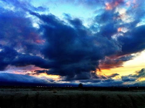A woman stands on the rocky sunbeams and storm clouds over appalachian mountains from blue r. Dramatic storm clouds roll over the mountains just west of ...