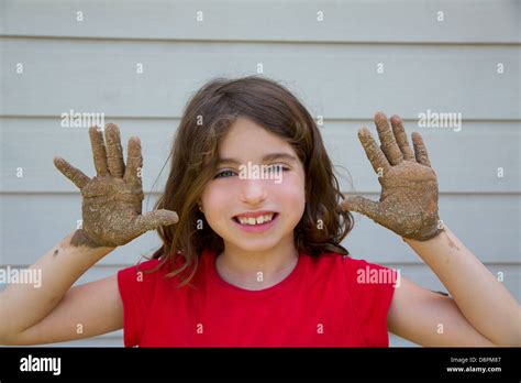 Happy Kid Girl Playing With Mud With Dirty Hands Smiling Portrait Stock Photo Alamy