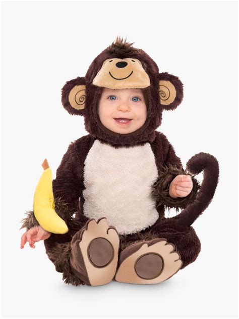 A Baby Wearing A Monkey Costume Sitting On The Floor With A Banana In