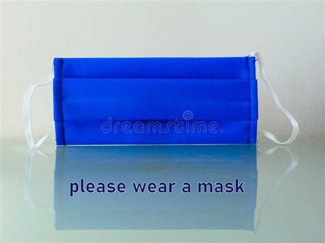 Blue Face Mask With Warning Sign To Wear A Face Mask Stock Image