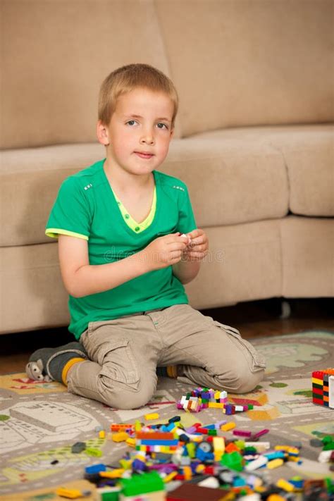 Young Boy Playing With Blocks On The Ground In Living Room Stock Image