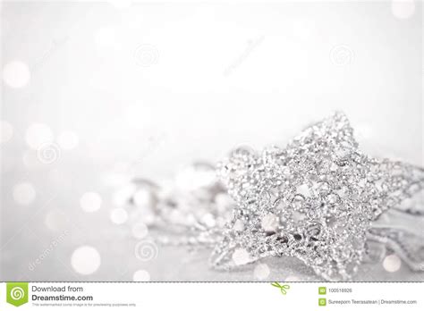 Star And Shiny Silver Ornaments On Bright Abstract Background Bokeh