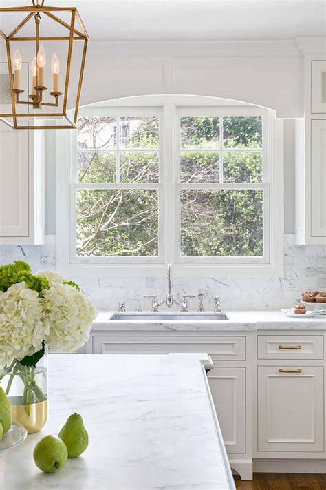 A lot of people like looking out of the window as they wash up. White Kitchen with Stacked Cabinets and Grey Island - Home ...