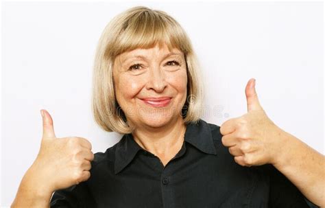 Portrait Of Cheerful Old Woman In Blue Shirt Showing Thumbs Up Gesture